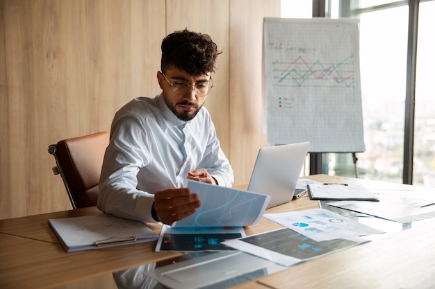 Free photo office worker using finance graphs