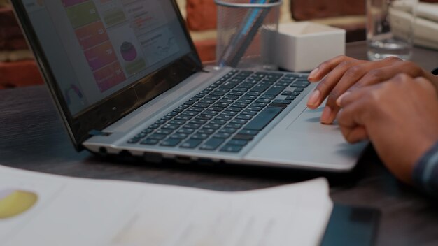 Office worker using laptop to work on company innovation, planning financial project for business development and growth. Manager creating authentic strategy for accountant career. Close up