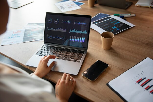 Office workers using finance graphs