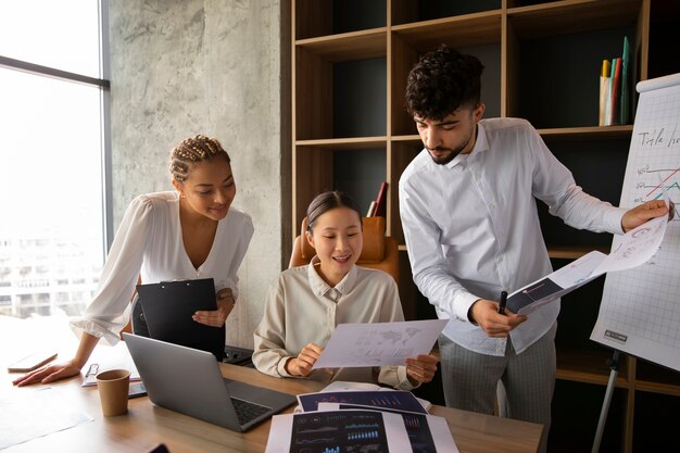 Office workers using finance graphs