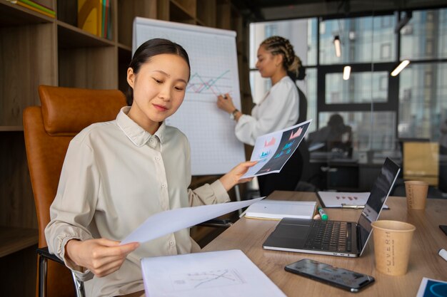 Office workers using finance graphs