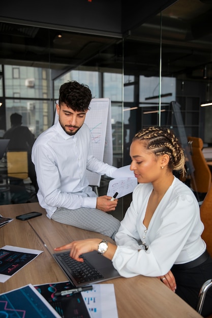 Office workers using finance graphs