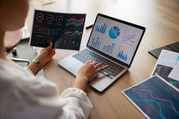 Office workers using finance graphs