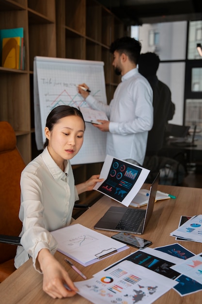 Free Photo office workers using finance graphs