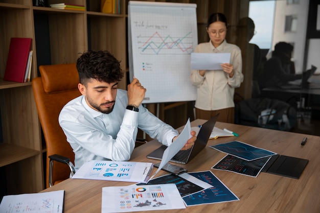 Free photo office workers using finance graphs