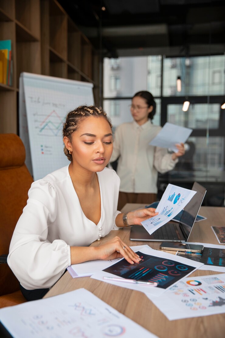 Free Photo office workers using finance graphs