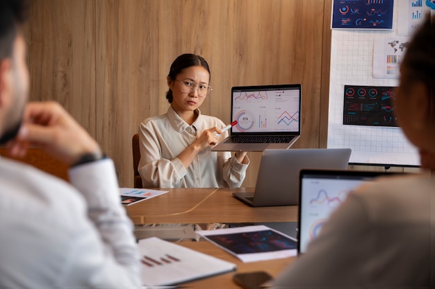 Office workers using finance graphs