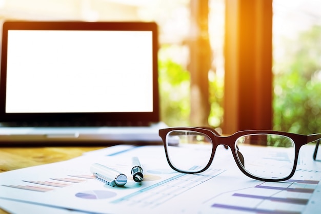 Free photo office workplace with laptop and glasses on wood table.