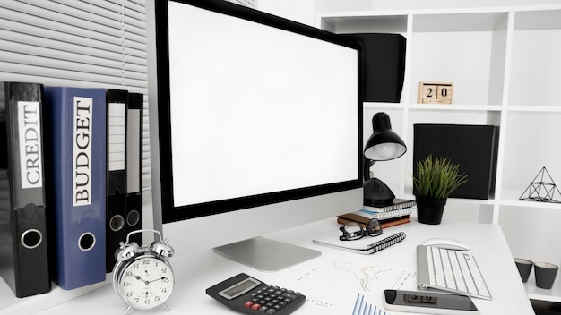 Office workspace with computer screen and lamp