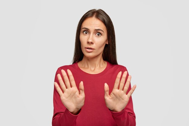 Oh no, stop there. Serious beautiful woman rejects offer, pulls palms in no gesture