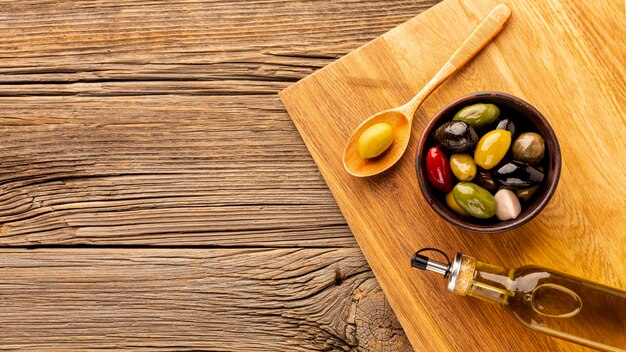 Oil bottle olive bowl and wooden spoon with copy space