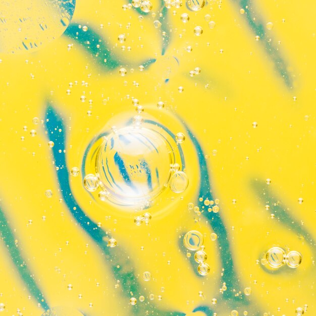 Oil bubbles floating on beautiful pattern yellow background