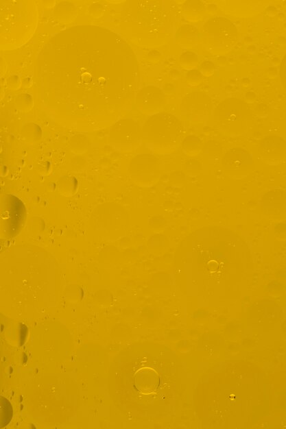Oil bubbles floating on golden background
