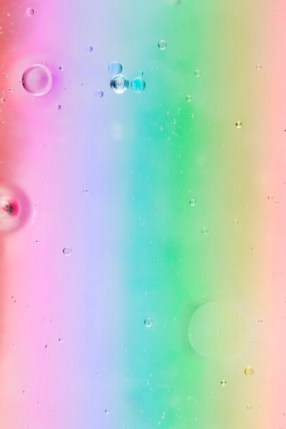 Oil bubbles floating on multi colored background