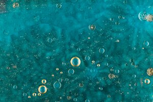 Oil bubbles over green water surface
