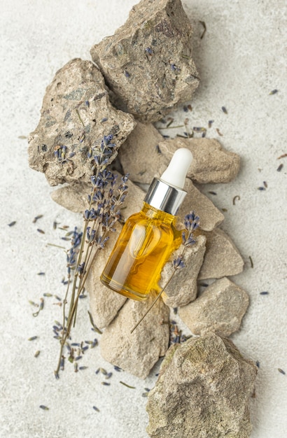 Oil dropper and lavender on rocks