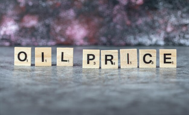 Oil price writing with black letters on wooden dices in horizontal manner. High quality photo