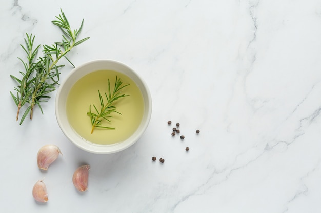 Free photo oil with rosemary on table