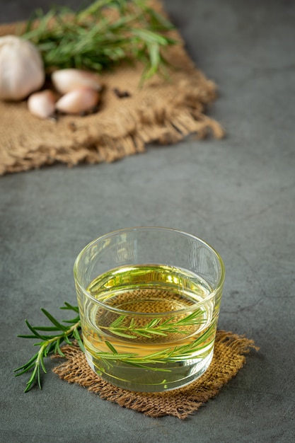 Free photo oil with rosemary on table