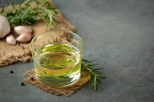 Free photo oil with rosemary on table