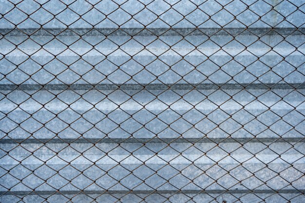 Old aluminum galvanized background covered with wire mesh grille. Metal texture