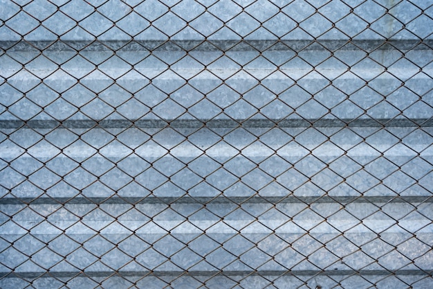 Старый алюминиевый оцинкованный фон, покрытый решеткой из проволочной сетки. Металлическая текстура