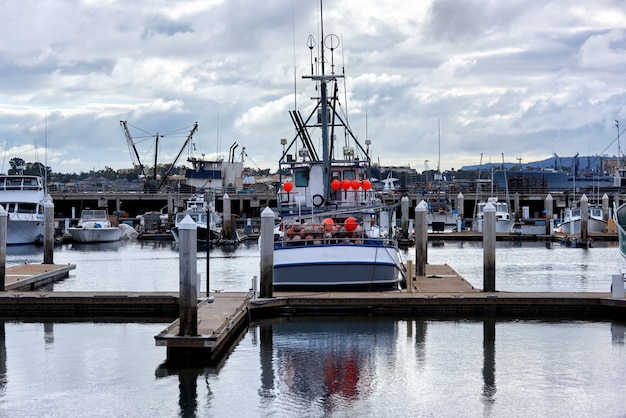 Old Boats in a port and a pier in the evening