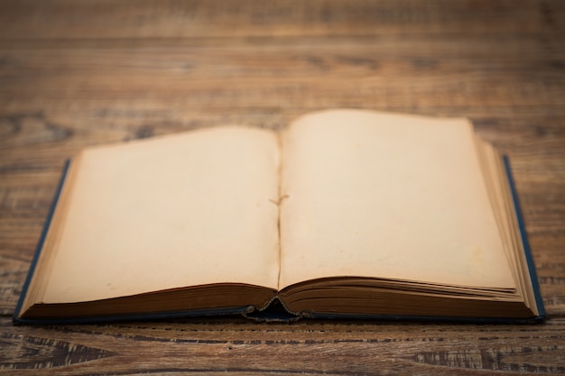 Old book open on a wooden table