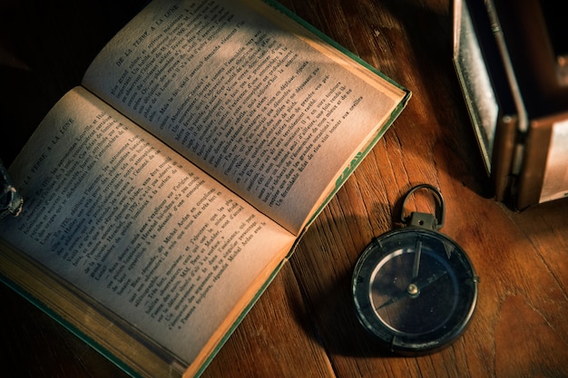 Free photo an old book on a wooden table