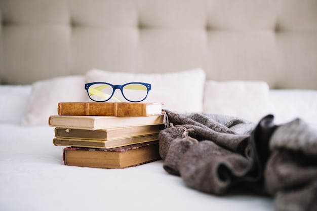 Free photo old books and glasses near blanket