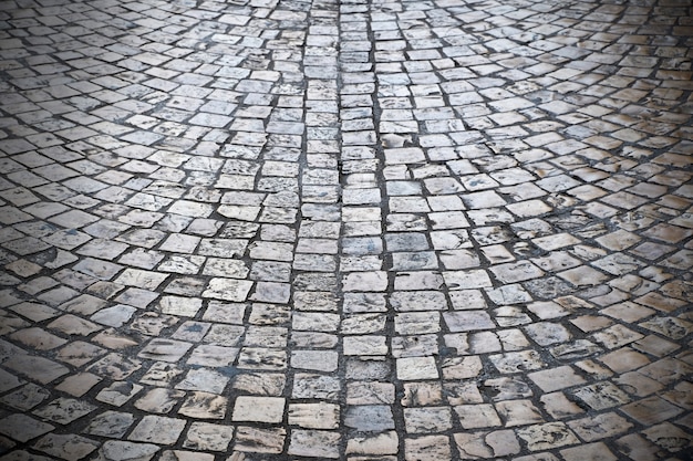 Бесплатное фото Старый булыжник улицы фоновой текстуры темный виньетка