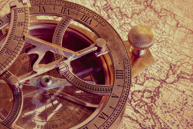 Free photo old compass over ancient map