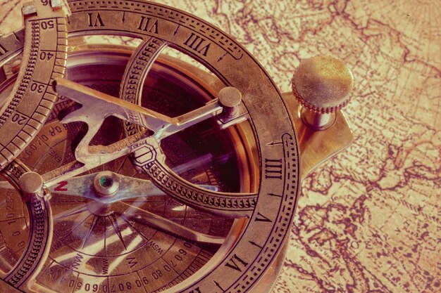 Old compass over ancient map