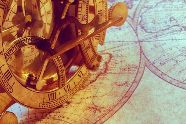 Old compass over ancient map