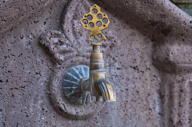 Old copper faucet in a public place on the street of the old city in Turkey travel time idea for background