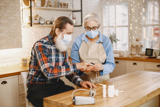 Old couple in a kitchen.