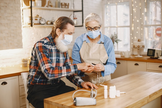 Old couple in a kitchen.