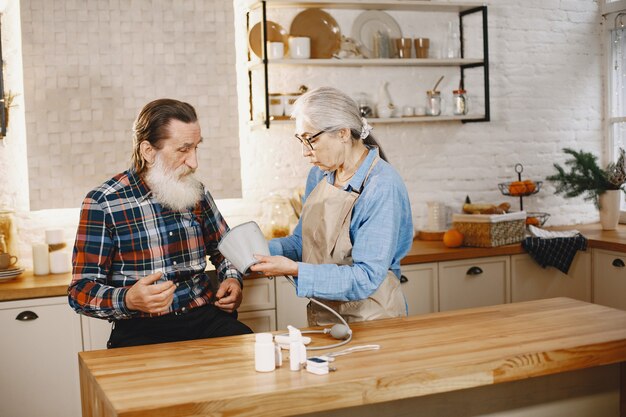 Old couple in a kitchen.