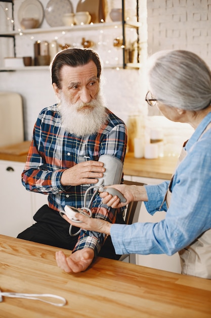 Old couple in a kitchen.