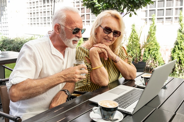 Old couple looking at a laptop