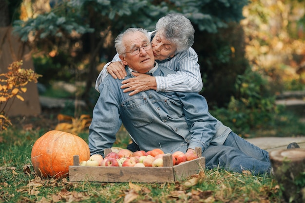 収穫と夏の庭に座っている老夫婦