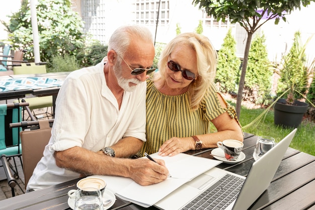 old couple taking notes in agenda