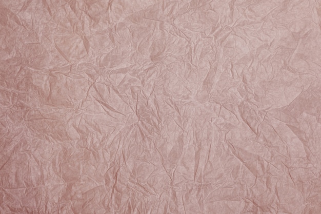 Старый скомканный серый бумажный фон текстуры. Старая мятой пастельной розовой бумаги фоновой текстуры
