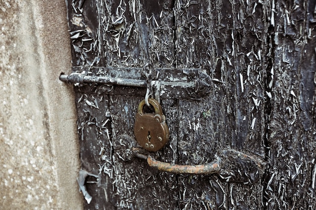 Old door with paint peelings and lock