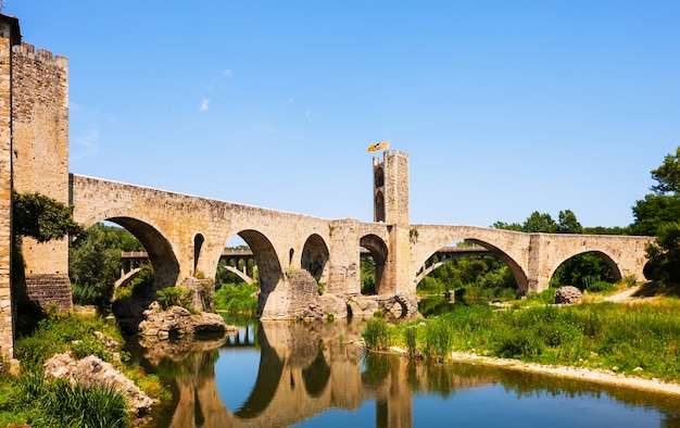 Old european town with medieval bridge over  river