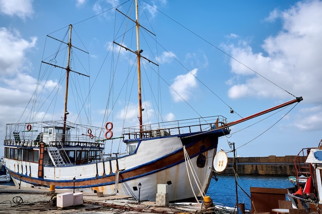 Old fishing boat in a port in the evening