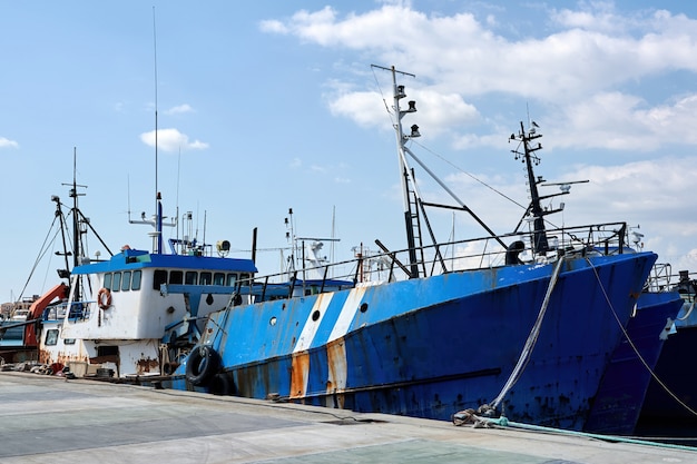 Old fishing ship in a port in the evening