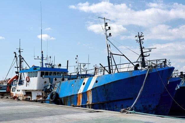 Old fishing ship in a port in the evening