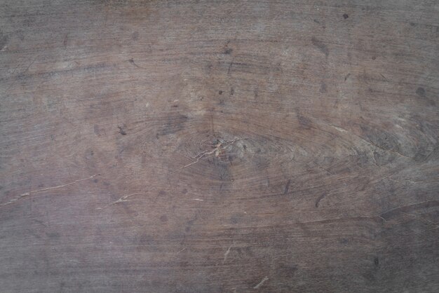 Old knot on a wooden board close up