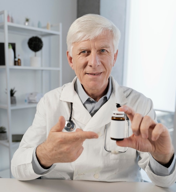 Free photo old male doctor in his office